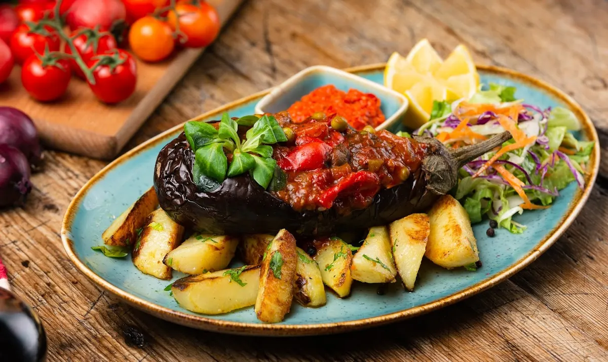 Imam Bayildi — stuffed eggplant with potatoes and salad