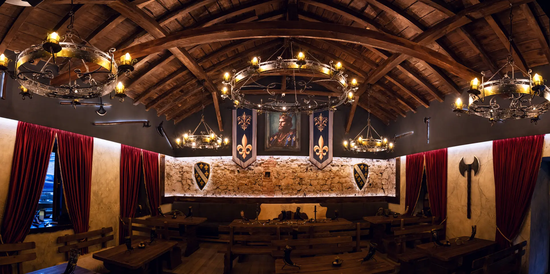 Timber & Stone Tavern interior — stone walls, oak tables, candlelight